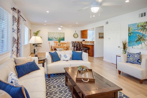 Main living spaces looking from front entry area. Open floor plan between living, kitchen and dining areas.
                
