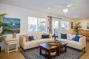 View of main living spaces from the front entry. Open floor plan between living, kitchen and dining areas.
                