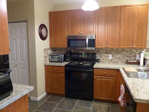 Kitchen with granite counters and double sink with garbage disposal.