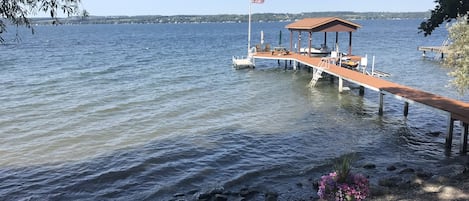 Permanent dock with lower dock & stone beach.