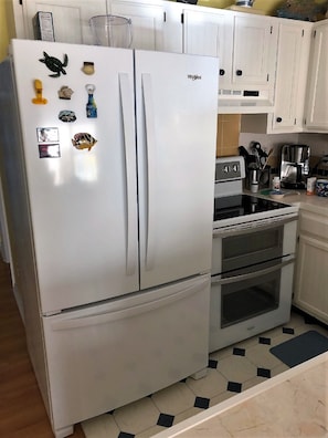 Brand new French door refrigerator with bottom freezer and ice maker.