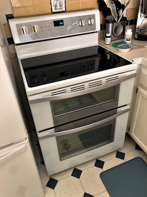 Brand new double oven with glass-top range.