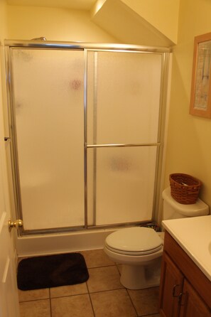 Full Bathroom with shower. Located downstairs by bedrooms. 