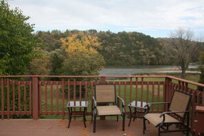 Deck overlooks large yard and waterfront.