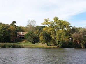 The view from the water looking at the waterfront up to the house.