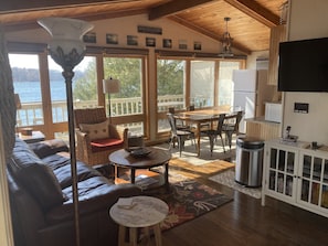 View of the kitchen and living room from the front door w/ beautiful lake views.