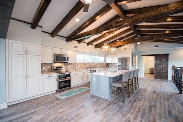 Expansive open concept kitchen leads into the dining and living areas.