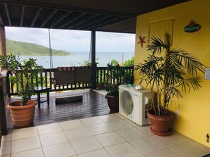 First View At Bottom Of The Stairs With View Of The Bay And Double Padded Swing