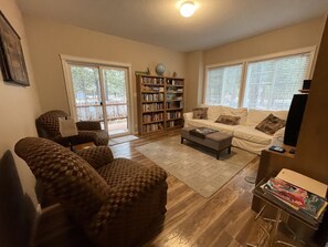 Front Living Rm, large sofa,TV, vhs & tapes, vintage PlayStation & games, books
