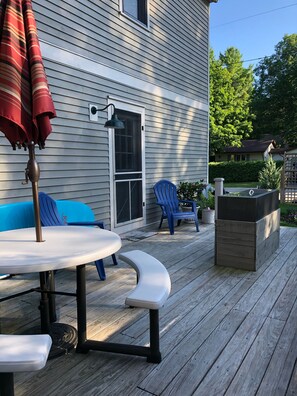 Back Deck with bench seating and a gas fire pit.