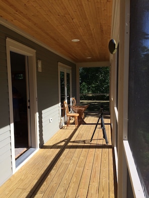 Front porch is screened so doors can be left open to expand the living space.