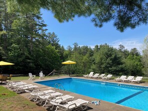 Pool opens Memorial weekend - plenty of lounge chairs for basking in the sun . 