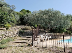 Private pool and short path to villa. Pool has attractive iron fence for safety.