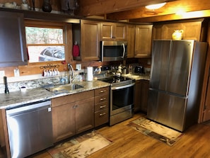 Newly renovated, nicely furnished kitchen open to the living room.