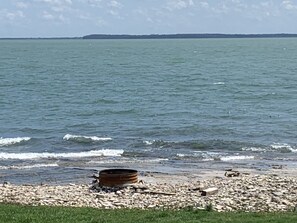 Waterfront fire ring with firewood provided