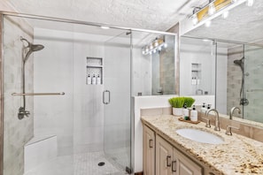 Modern updated walk-in showers with full-view glass walls.