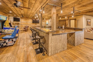 Basement features a full size bar, beverage cooler, kegerator, ice maker, arcade games, pool table, multiple tv - truly an entertainment paradise.