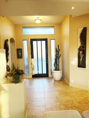 Main Entry With Tastefully Decorated Artwork and Sculptures