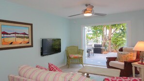 My spacious living room w/ 40" tv set and double french doors to back deck