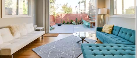 Downstairs media-family room with patio door/wall fully open to garden