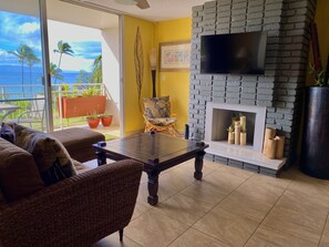 Living room with TV mounted on fireplace.