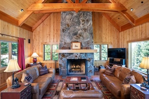 Living Room with vaulted ceilings and rock fireplace.