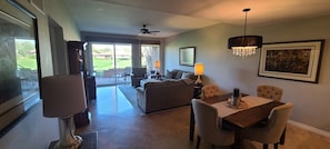 The living room has a great view of the golf course and open to the dining room