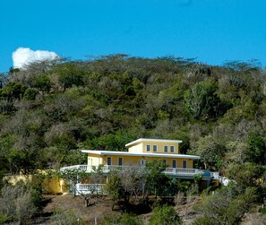 View of our hillside home and part of the land from across the valley.