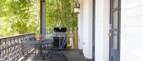 front porch table with bouncy chairs and natural gas bbq 