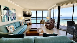 Spacious living area with floor to ceiling views of the beach