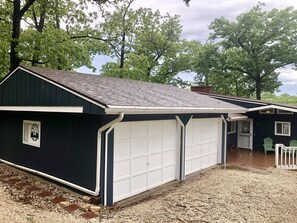 Front of house. 2 car spots in front of the garage, 2 on side of the garage
