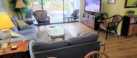 Living room and patio beyond, looking from dining room