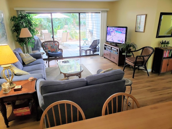 Living room and patio beyond, looking from dining room