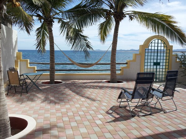 Beachfront patio is sheltered from wind: spread out your gear to dry, and relax!