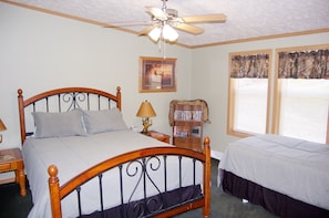 Master bedroom with queen and twin bed. Also has roll-away bed in walk-in closet