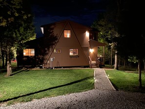 Front of chalet at night; plenty of outdoor lighting