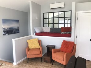 Cozy reading nook with twin mattress and perfect chairs to soak in the view