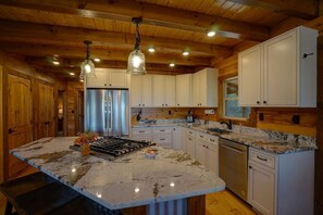 Plenty of counter space with a large island with 3 bar stools for extra seating