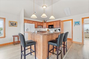 Family feasts can easily be prepared in the spacious kitchen, located on the top level.