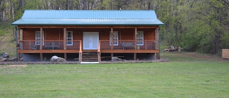 Front of cabin w/ 2 swings on front porch