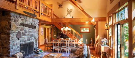 Open plan with fireplace, TV seating and Farm Table with Adjoining Patio