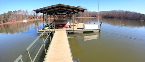 Dock with sun bathing area and swing!  +16 feet deep and plenty of boat parking!