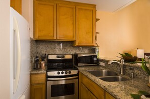 Kitchenette - small but well stocked w/ 4 burner stove and large fridge