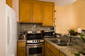 Kitchenette - small but well stocked w/ 4 burner stove and large fridge