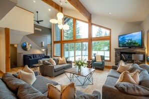 The great room has plenty of light, seating and a cozy gas fire for the winter.