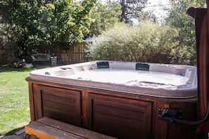 Hot tub is nestled into the landscaping for privacy
