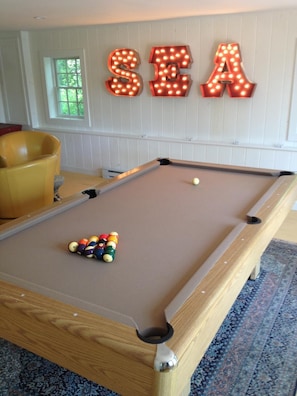 Play a game of pool in the guest house to unwind after the day at the beach