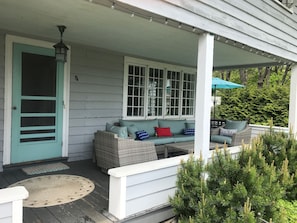 The front porch provides comfortable seating and views of the ocean