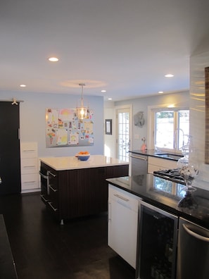 The renovated kitchen offers modern conveniences in a 1920s beach cottage