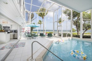 6 panel sliding door opens onto the private pool deck, fully screened in